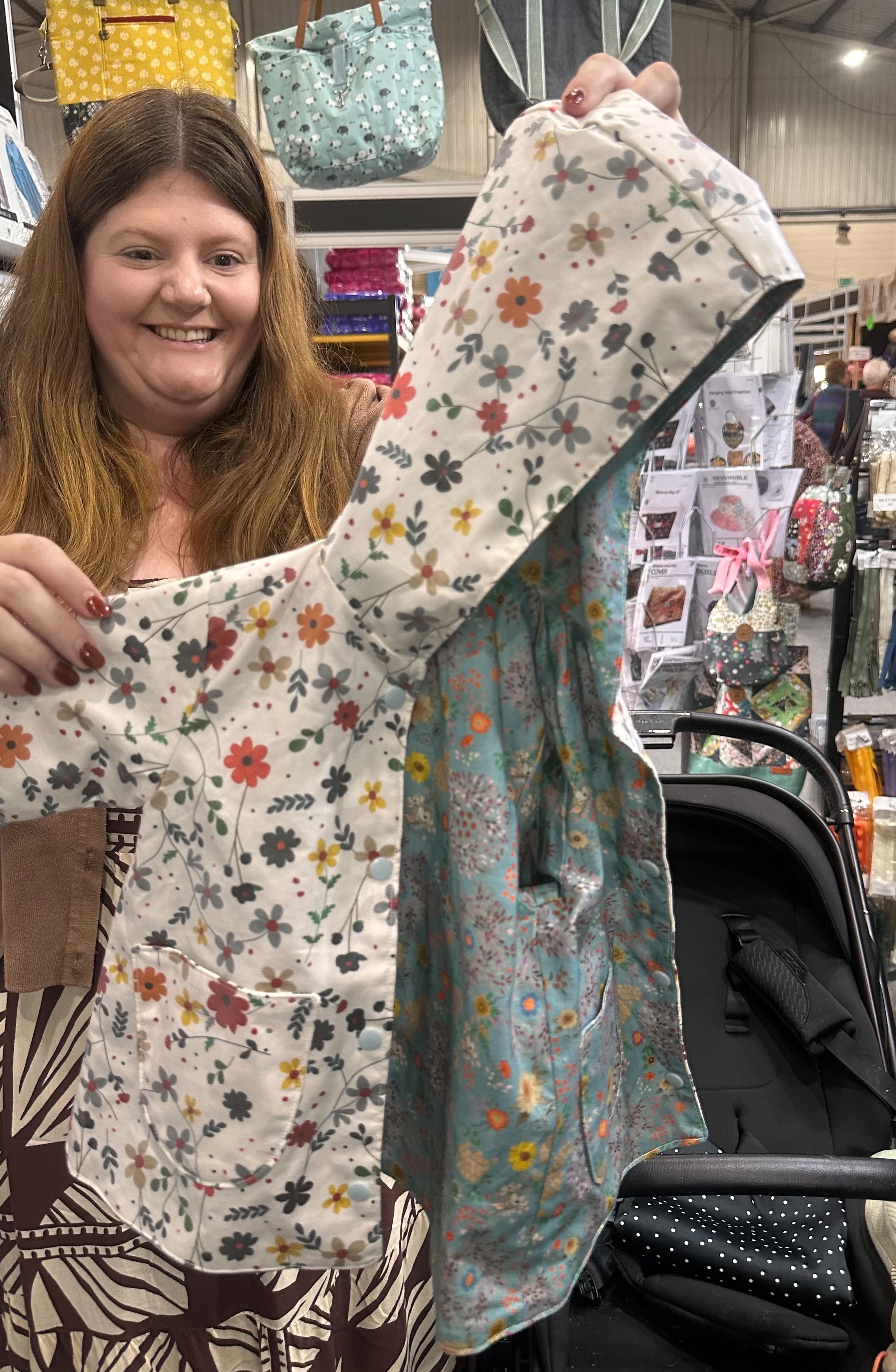 Customer holding homemade kids raincoat. eco-laminated Sounds like summer (white) on the outside; cotton Swirl with Swirl green lining