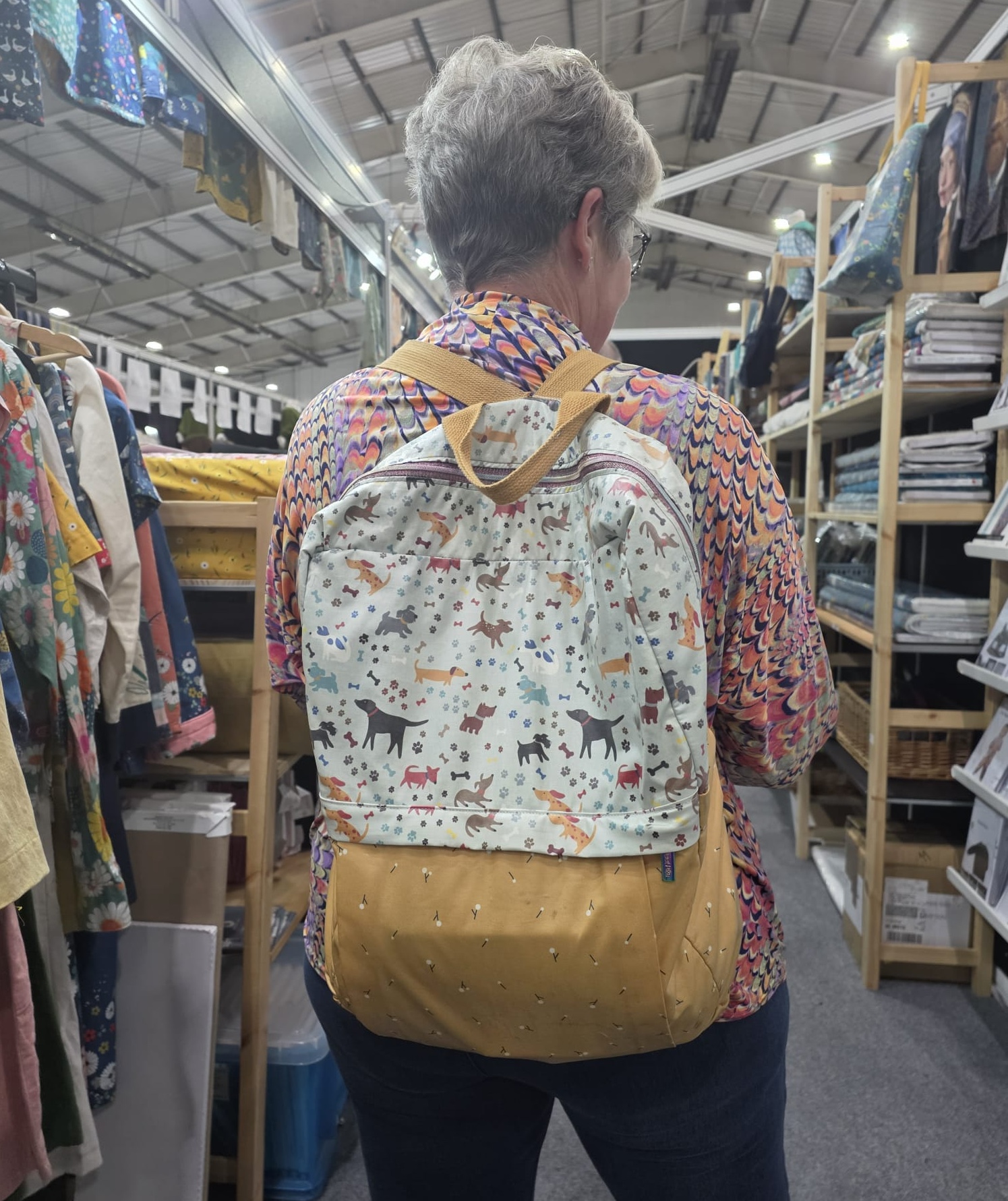 Customer at Exeter Show with homemade Olivia Backpack; eco-laminated tweety tweety & what a joy grey.