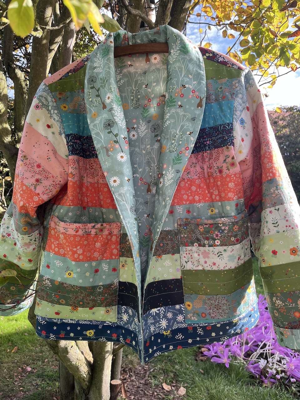 patchwork homemade Somerset jacket. Multi-coloured, multi-design outside. Jelly roll. lining is cotton chanting meadow sage