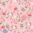 My Little Garden eco-laminated fabric in baby pink, featuring a scattered floral pattern with white, coral, red, and blue blooms, taupe flowers, and green foliage on a pink background