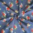 Garden Rose cotton fabric in medium sapphire, featuring a pattern of red, pink, and cream roses with white and navy florals, green foliage, and coral berry sprigs on a deep blue background