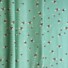 Bee World (sea foam) cotton fabric featuring a scattered pattern of illustrated bumblebees in black, yellow, and white on a green background.