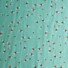 Bee World (sea foam) cotton fabric featuring a scattered pattern of illustrated bumblebees in black, yellow, and white on a green background.