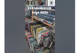 Video thumbnail showing colourful fabric rolls at the Sewing‑Sanctuary stand in Farnborough, September 2026.